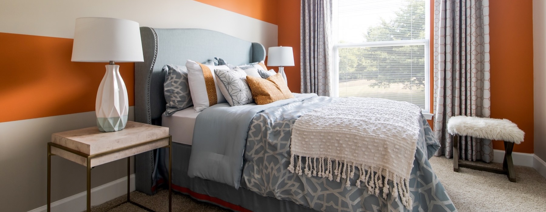 a bedroom with a bed and lamps